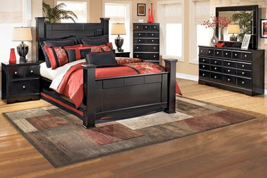 Inspiration for a large master medium tone wood floor bedroom remodel in Charlotte