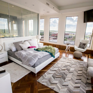 Photo of a contemporary master bedroom in Other with white walls and dark hardwood flooring.