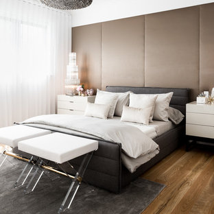 This is an example of a mid-sized contemporary master bedroom in Melbourne with white walls, medium hardwood floors, no fireplace and brown floor.