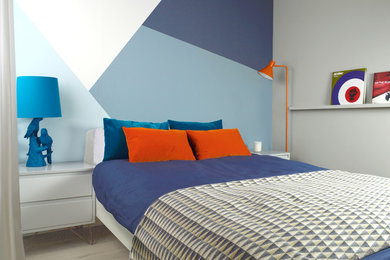 Example of a mid-sized minimalist master laminate floor bedroom design in London with multicolored walls
