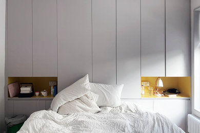 Design ideas for a large modern master bedroom in London with white walls.