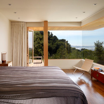 Bedroom with built in storage, hardwood floors, and lots of natural light
