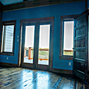Bedroom with rustic hardwood flooring, reclaimed door