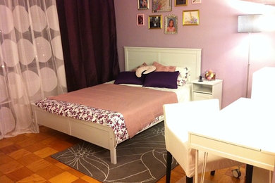 This is an example of a small modern guest bedroom in Raleigh with purple walls.