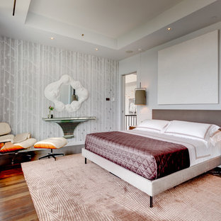 Trendy medium tone wood floor bedroom photo in New York with multicolored walls
