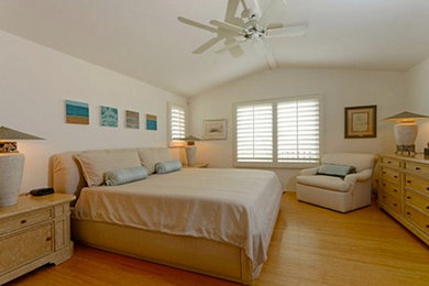 Inspiration for a mid-sized guest light wood floor bedroom remodel in Other with white walls