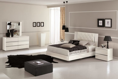 Bedroom - transitional concrete floor bedroom idea in Boston with beige walls
