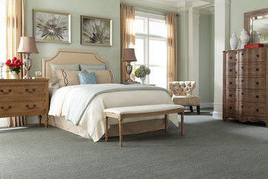 Example of a large classic master carpeted bedroom design in Other with green walls