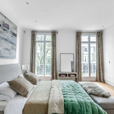 Inspiration for a mid-sized contemporary master light wood floor and beige floor bedroom remodel in London with gray walls and no fireplace