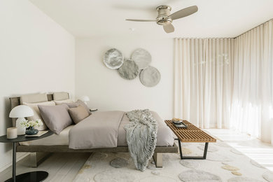 Example of a mid-sized trendy guest porcelain tile and white floor bedroom design in Los Angeles with white walls