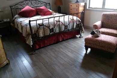 Bedroom - mid-sized traditional guest dark wood floor bedroom idea in Other with white walls
