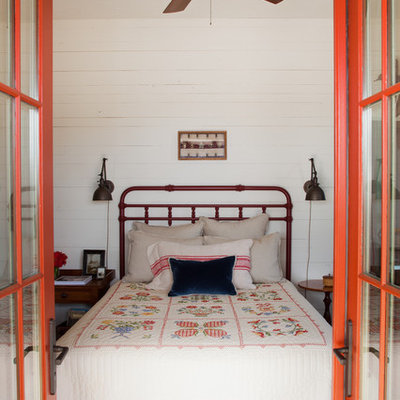 Example of a farmhouse bedroom design in Atlanta with white walls