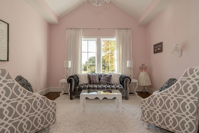 Example of a mid-sized transitional medium tone wood floor bedroom design in Dallas with pink walls