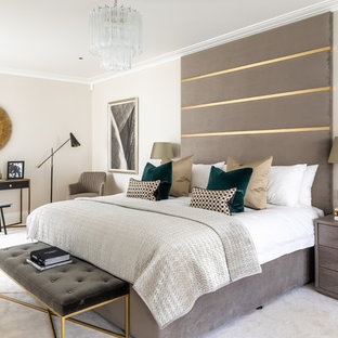Design ideas for a contemporary master bedroom in London with beige walls, carpet and beige floors.