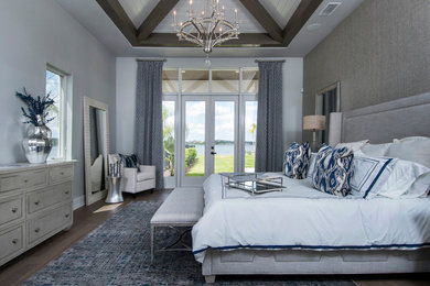 На фото: хозяйская спальня среднего размера в современном стиле с серыми стенами и коричневым полом без камина