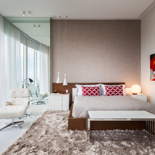 Bedroom - large contemporary master porcelain tile bedroom idea in Miami with beige walls