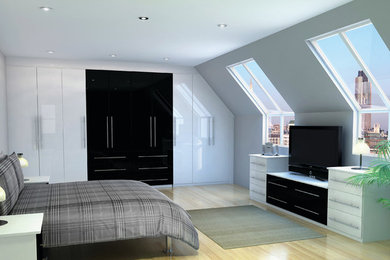 This is an example of a large modern mezzanine bedroom in West Midlands with white walls and light hardwood flooring.
