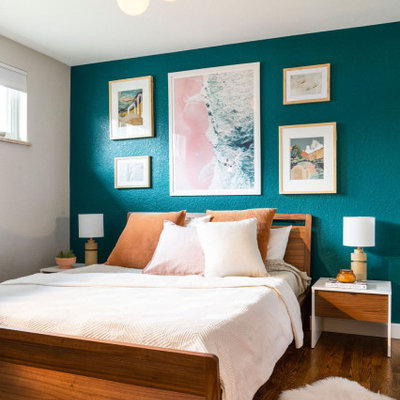 Inspiration for a mid-sized coastal master medium tone wood floor and brown floor bedroom remodel in Denver with blue walls and no fireplace