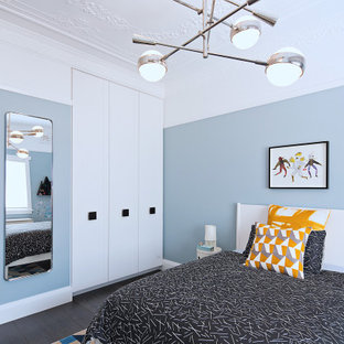 Inspiration for a contemporary bedroom in Sydney with blue walls, dark hardwood floors and brown floor.