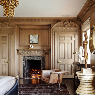 Design ideas for an eclectic master bedroom in Los Angeles with brown walls, dark hardwood floors, a standard fireplace and a stone fireplace surround.