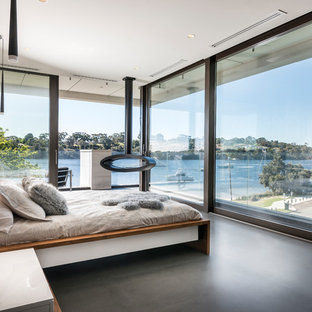 Photo of a large contemporary bedroom in Perth with black floor.