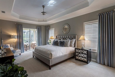 Example of a mid-sized transitional master carpeted and beige floor bedroom design in Tampa with gray walls and no fireplace