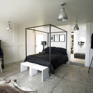 Diseño de dormitorio industrial con suelo de cemento y suelo gris