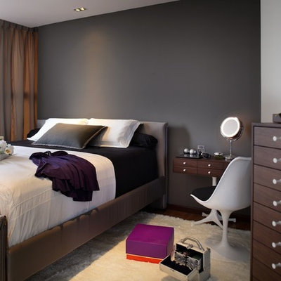 Trendy bedroom photo in Singapore with black walls and no fireplace