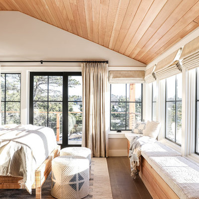 Mid-sized beach style master medium tone wood floor and brown floor bedroom photo in Portland Maine with white walls