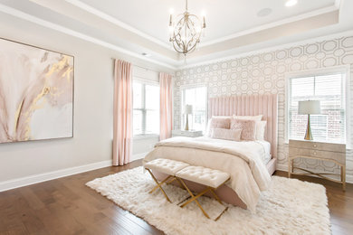Transitional master medium tone wood floor, brown floor and wallpaper bedroom photo in Atlanta with beige walls