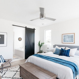 Bedroom - coastal dark wood floor and brown floor bedroom idea in Los Angeles with white walls