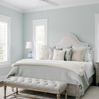 Inspiration for a mid-sized coastal master dark wood floor and brown floor bedroom remodel in Jacksonville with green walls