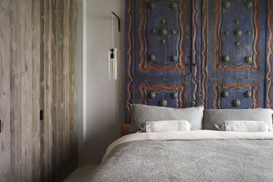 Eclectic bedroom photo in New York with gray walls