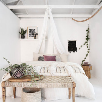 Bohemian beach style bedroom featuring handmade wall hangings