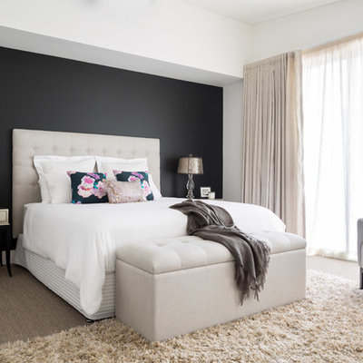 Example of a trendy master carpeted bedroom design in Sydney with black walls