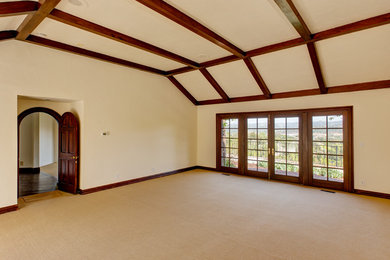 Photo of a large rustic master bedroom in Los Angeles with beige walls, carpet and beige floors.