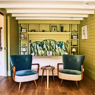Imagen de habitación de invitados tropical, de tamaño medio, con paredes verdes, suelo de madera en tonos medios y suelo marrón