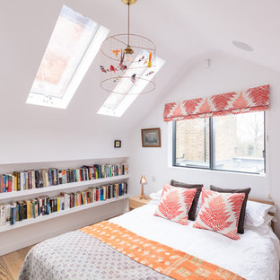 Inspiration for a traditional bedroom in London with white walls, medium hardwood flooring and brown floors.