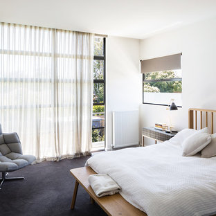 Photo of a contemporary guest bedroom in Melbourne with white walls, carpet and grey floor.