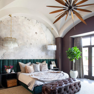 Photo of a mediterranean bedroom in Charlotte with brown walls, brown floor and wallpaper.