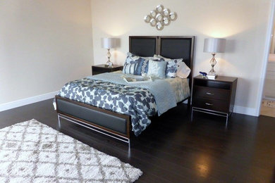 Photo of a large traditional master bedroom in Miami with beige walls, dark hardwood flooring and no fireplace.