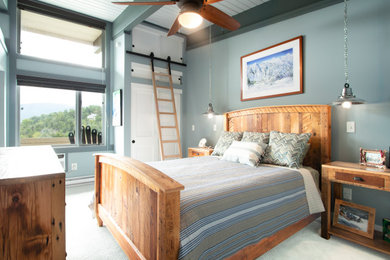 Photo of a large industrial guest bedroom with grey walls, carpet and green floors.