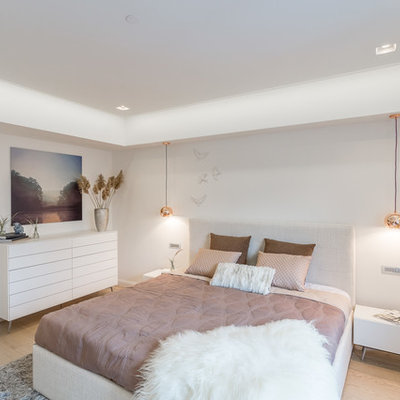 Example of a mid-sized trendy master light wood floor and beige floor bedroom design in Manchester with white walls
