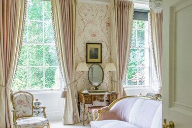 Inspiration for an expansive traditional master bedroom in Edinburgh with pink walls and carpet.