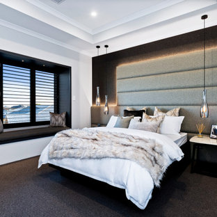 This is an example of a mid-sized contemporary master bedroom in Perth with white walls, carpet and black floor.