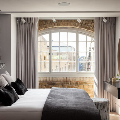 Trendy master beige floor bedroom photo in London with white walls