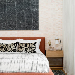 Large contemporary master bedroom in Brisbane with white walls, medium hardwood floors and brown floor.