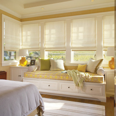 Inspiration for a timeless medium tone wood floor bedroom remodel in Orange County with beige walls and no fireplace