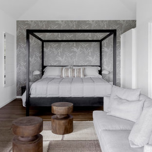 Design ideas for a contemporary master bedroom in Other with grey walls, dark hardwood floors, brown floor, vaulted and wallpaper.