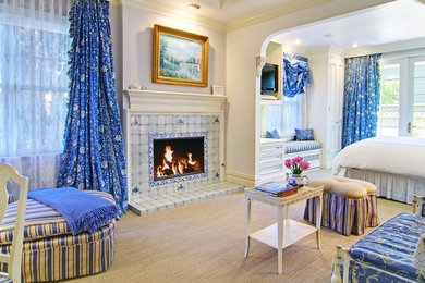 Example of a mid-sized ornate guest carpeted bedroom design in San Francisco with white walls, a standard fireplace and a tile fireplace